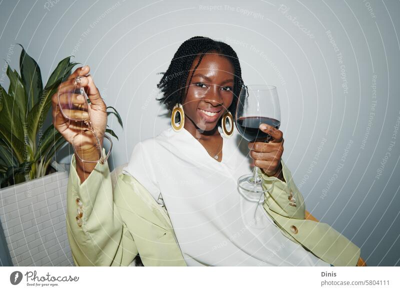 Young businesswoman drinking wine at office party alcohol positive smile flash excited drunk portrait Black woman celebrate friday workplace dressed fun happy