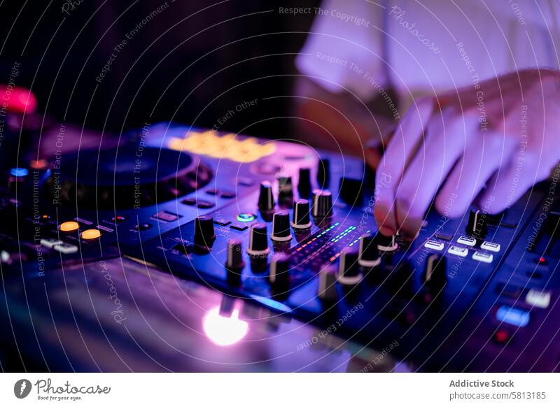 Nahaufnahme eines DJs bei der Arbeit am Mischpult in einem Club Hand dj Plattenteller Holzplatte Tisch mischen Musik Kaukasier jung unkenntlich berühren