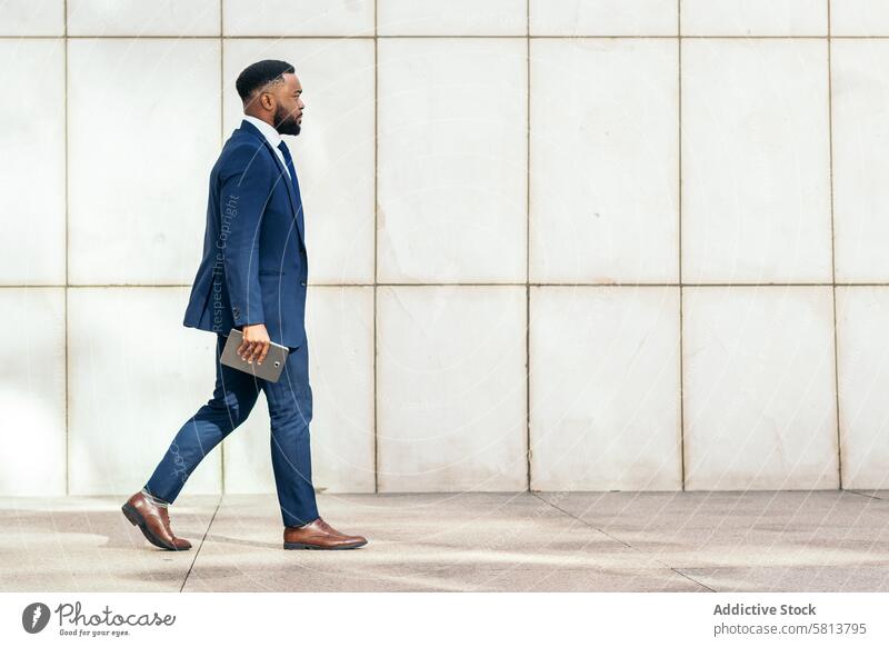 Seitenansicht einer schwarzen Geschäftsfrau im Anzug auf dem Weg ins Büro Geschäftsmann Fersen professionell Karriere Mode Arbeitsweg Erfolg Selbstvertrauen