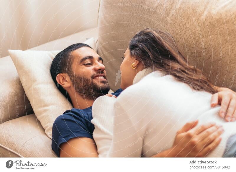 Romantisches Stockfoto von jungem Paar auf Sofa zu Hause junges Paar Romantik Liebe heimwärts gemütlich itim Partnerschaft Zusammensein Fröhlichkeit Komfort
