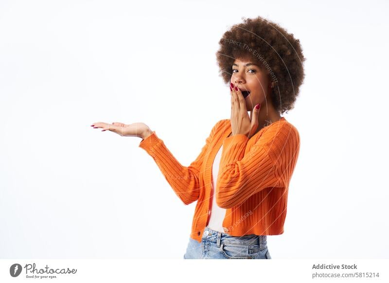 junge Latina Frau mit Afro Haar mit überraschten Geste Punkte mit der Hand isoliert weißem Hintergrund gestikulieren Porträt lateinamerikanisch Afro-Look
