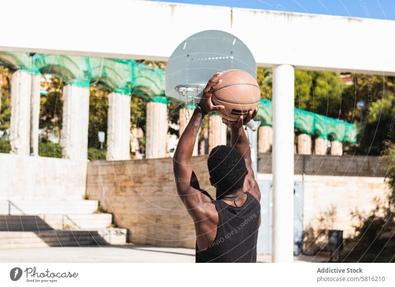 Anonymer schwarzer Mann spielt Basketball auf einem Sportplatz spielen Sportpark Spieler Sportler aktiv Ball Sommer männlich ethnisch Afroamerikaner Athlet üben
