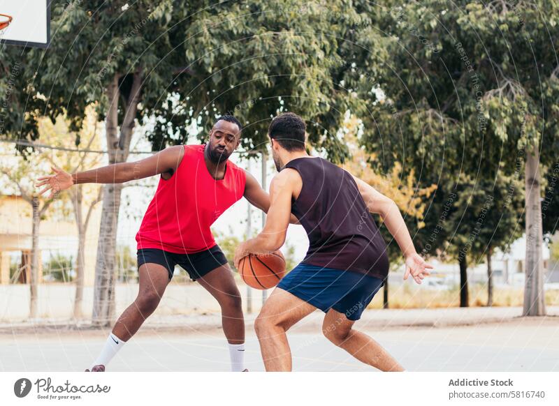 Männer dominieren den Basketballplatz Multirassische Freunde Basketballspiel Freundschaft Outdoor-Sportarten Konkurrenz Teamwork aktiver Lebensstil Gemeinschaft