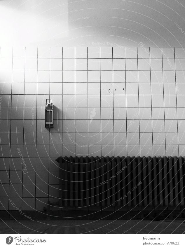 Light in cold room Licht bathroom white building light radiator dark heat soap dispenser shadow loneliness emptyness sad worn bw high contrast object Mauer