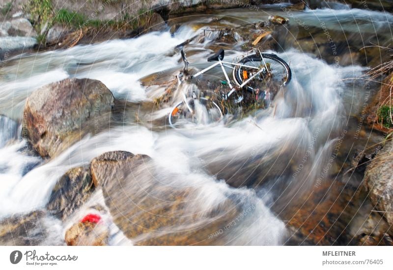 there is a bicycle in the river Bundesland Tirol Österreich water austira Fahrrad Fluss Wasser motion tyrol