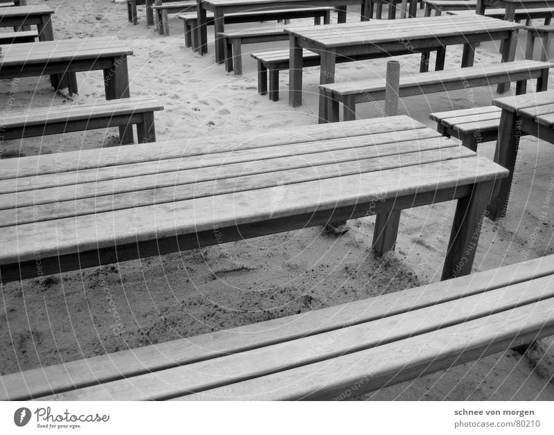draußen am strand horizontal Holz Tisch grau schwarz Strand Meer Sommer Winter Café Sitzgelegenheit Platz Ordnung Küste Gastronomie Schwarzweißfoto Linie Bank